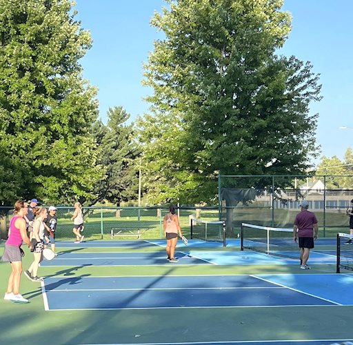 adults in pickleball play at iles park pickleball courts